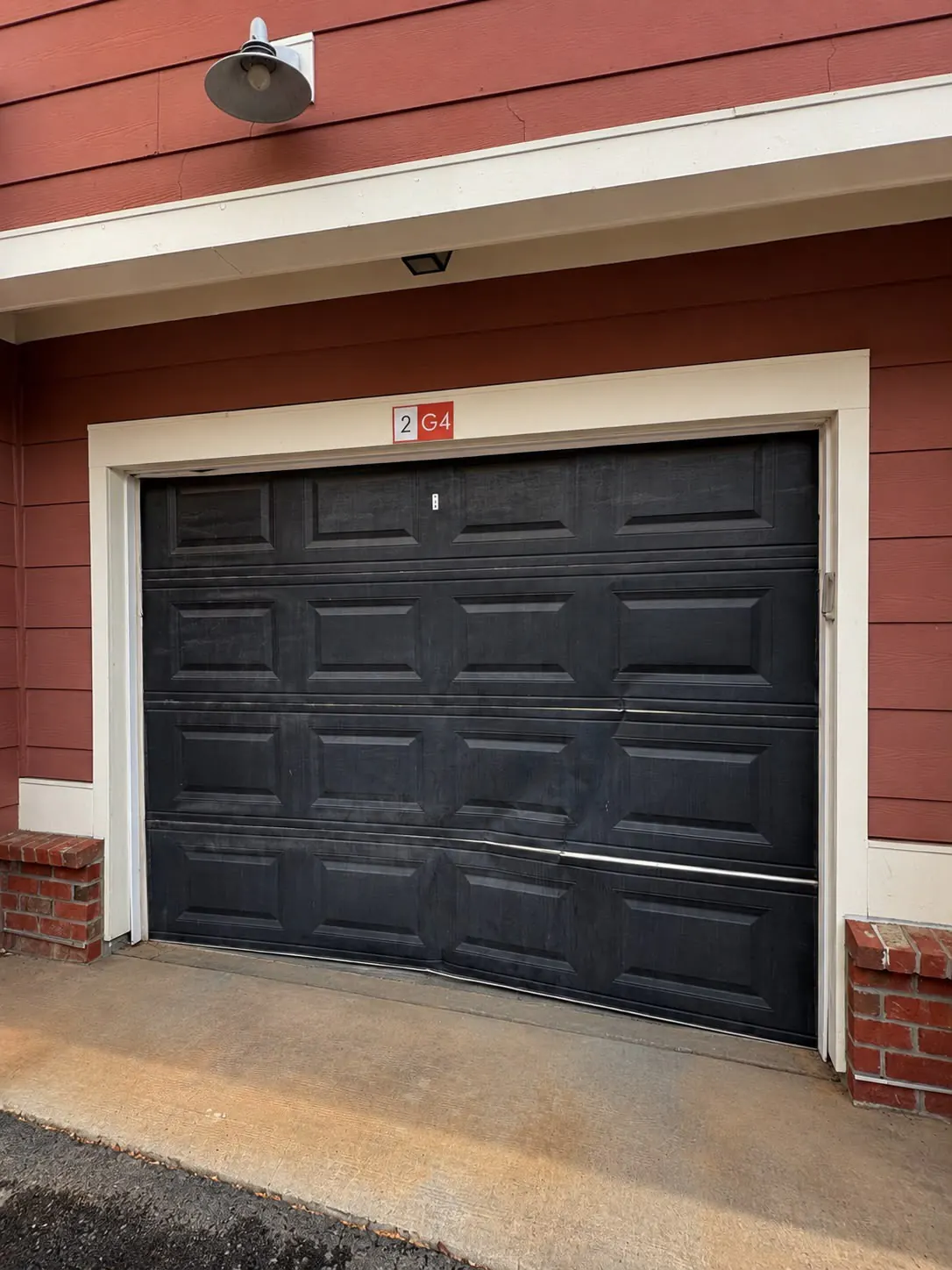 Dated garage door before installation of a new door