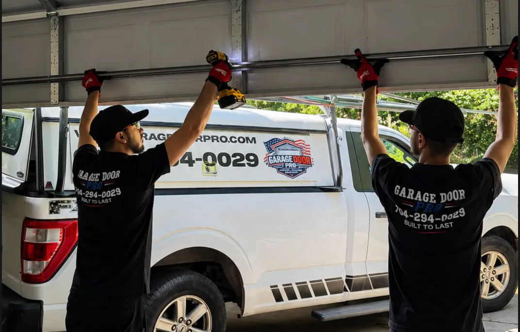 Garage Door Pro team installing new garage door panels - residential garage door installation